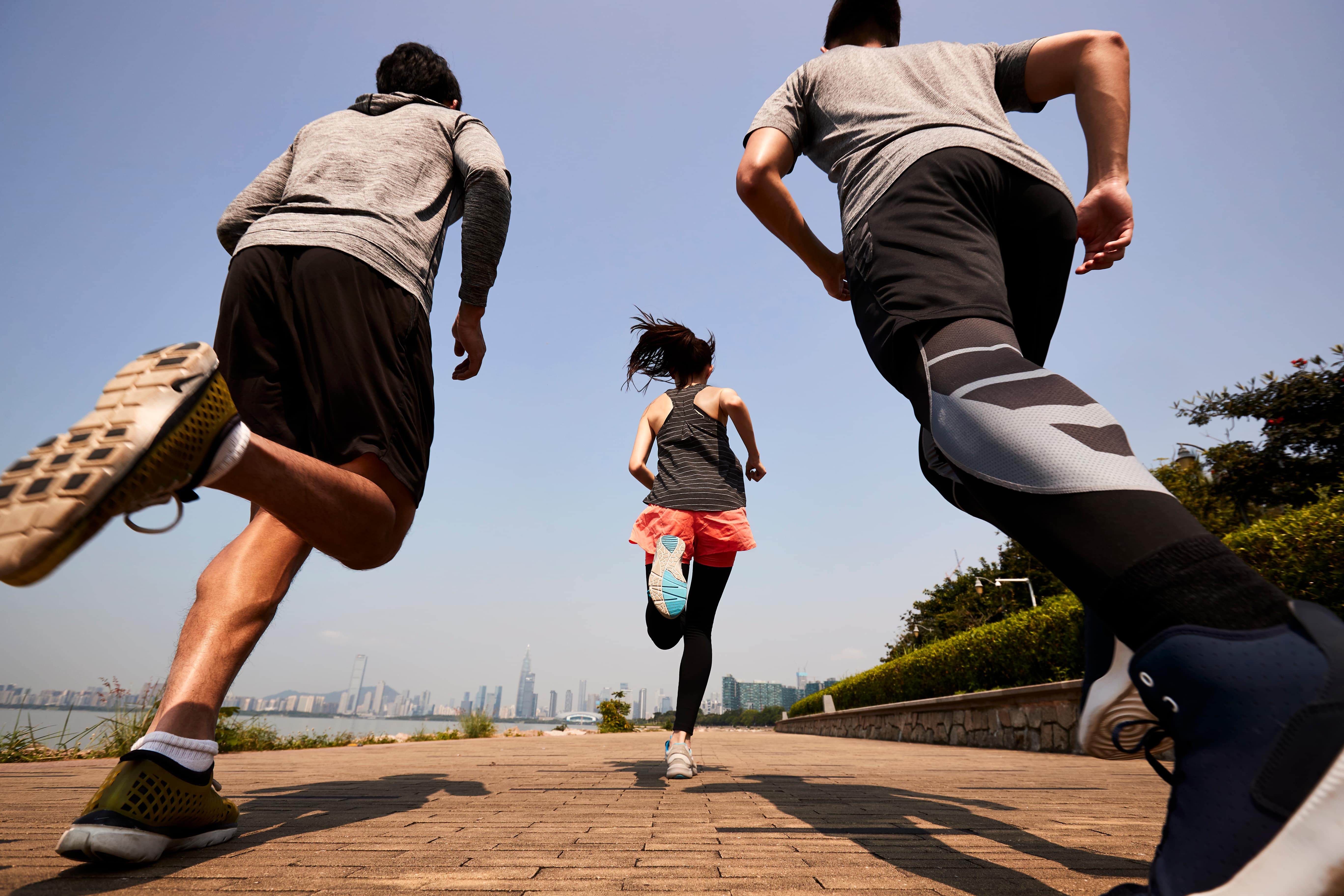 three people running away from a low cameraa angle